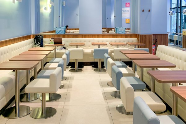 Seating area at the Waterfront store, a bag and laptop left on a table
