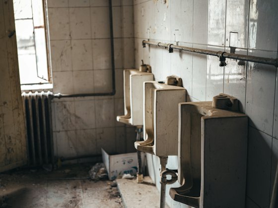 Worst store: A grimy row of urinals with debris on the floor