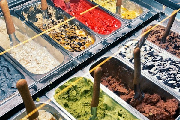 A display cabinet full of gelato tubs